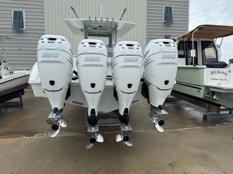 Slide: The Image of 2017 Yellowfin 39 Offshore boat with four powerful outboard engines, docked at a marina. - 26