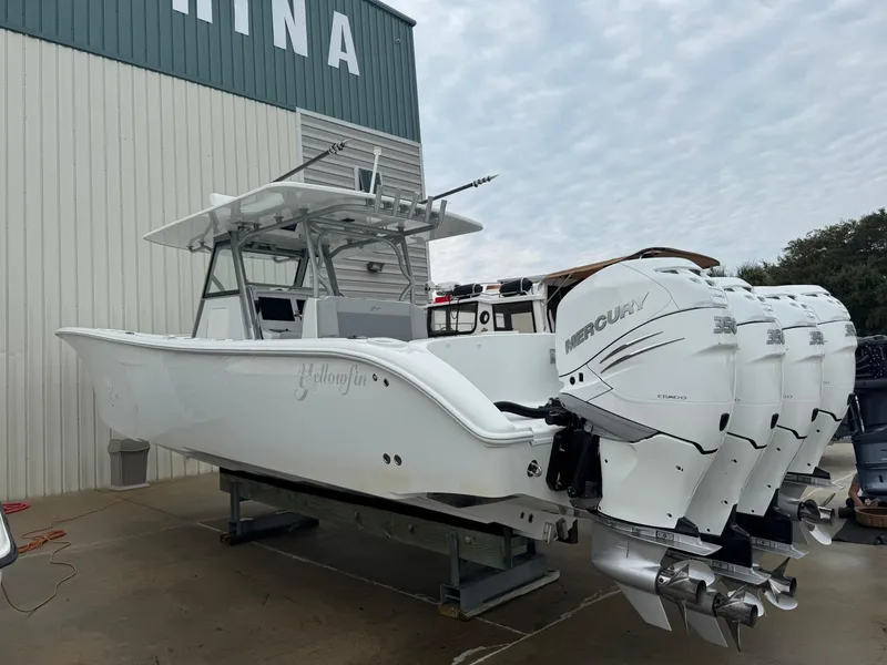 Slide: The Image of 2017 Yellowfin 39 Offshore boat with four Mercury engines, displayed outdoors. - 27