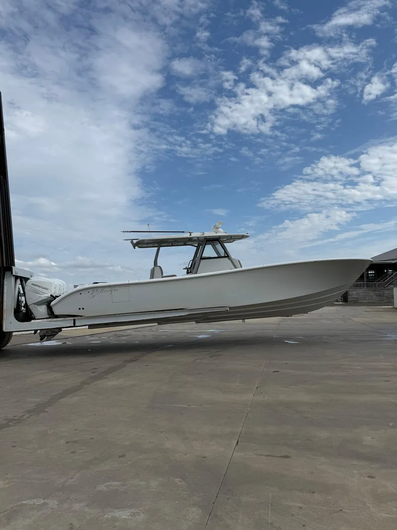 Slide: The Image of 2017 Yellowfin 39 Offshore boat on trailer under a partly cloudy sky. - 29