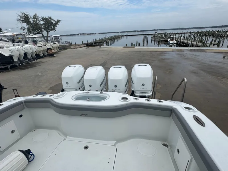 Slide: The Image of 2017 Yellowfin 39 Offshore boat with four outboard engines at a marina dock. - 6