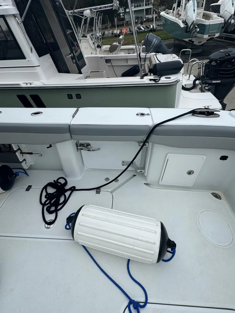 Slide: The Image of 2017 Yellowfin 39 Offshore boat deck with ropes and fender, docked at marina. - 7