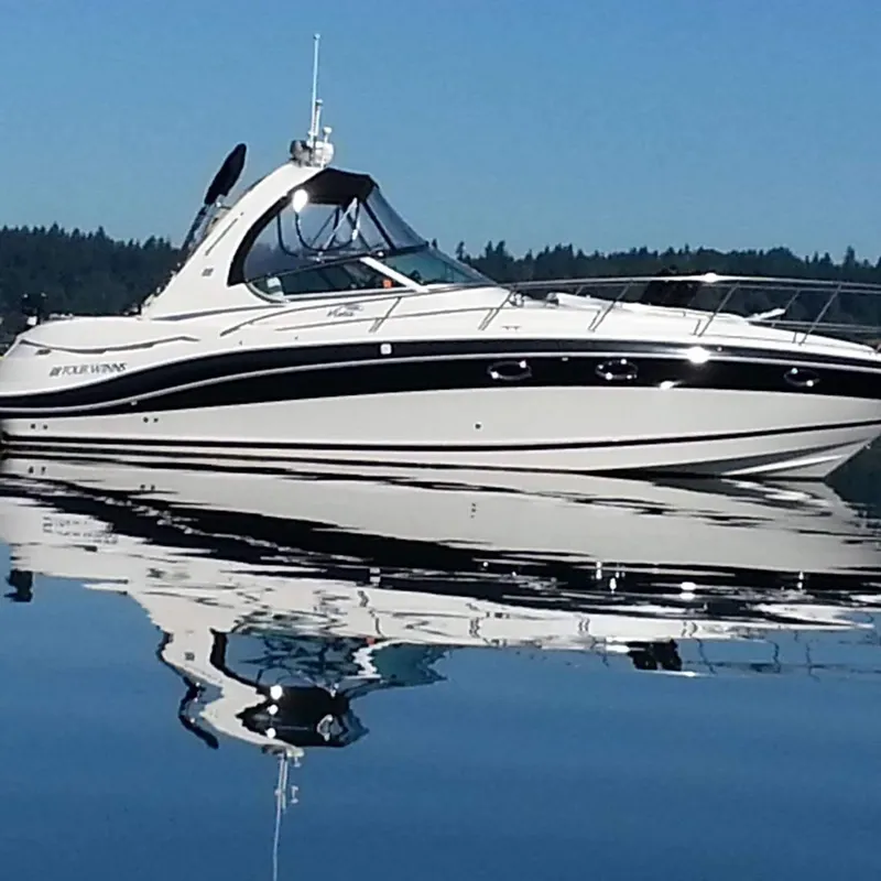 The Image of 2006 Four Winns 350 boat on calm water, reflecting clear blue sky. - 1