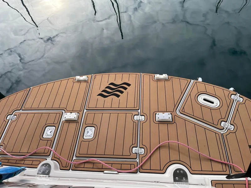 Slide: The Image of 2006 Four Winns 350 boat deck with wood finish and water reflection. - 10