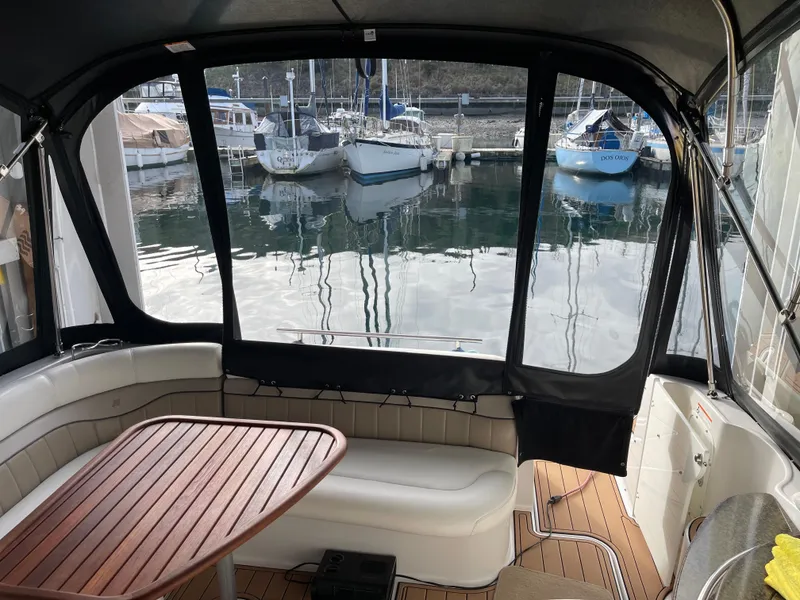 Slide: The Image of Interior view of 2006 Four Winns 350 boat with marina backdrop. - 12