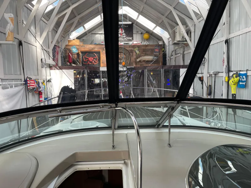 Slide: The Image of 2006 Four Winns 350 boat inside a spacious, well-lit storage facility. - 21