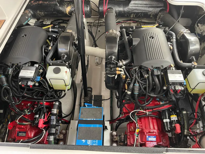 Slide: The Image of Engine compartment of a 2006 Four Winns 350 boat, featuring dual engines and wiring. - 23