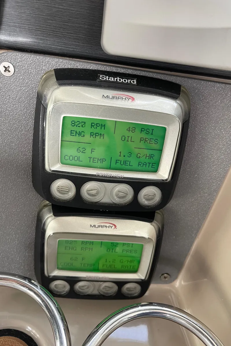 Slide: The Image of 2006 Four Winns 350 boat dashboard displaying engine RPM, oil pressure, coolant temperature, and fuel rate. - 24