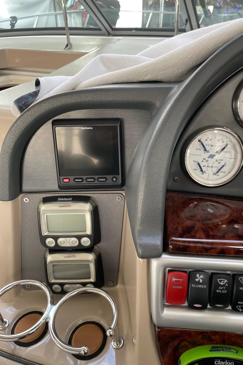 Slide: The Image of Control panel of a 2006 Four Winns 350 boat with gauges and cup holders. - 25