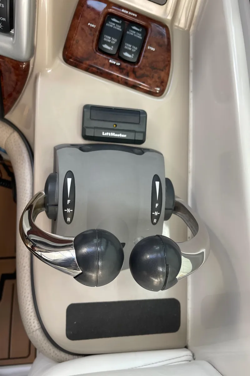 Slide: The Image of Throttle controls on a 2006 Four Winns 350 boat dashboard. - 29