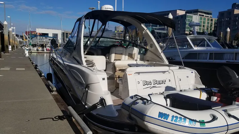 Slide: The Image of 2006 Four Winns 350 boat docked at marina with inflatable dinghy. - 3