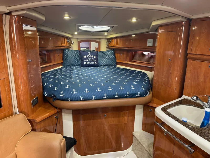 Slide: The Image of 2006 Four Winns 350 yacht interior with cozy bed and wooden cabinetry. - 39