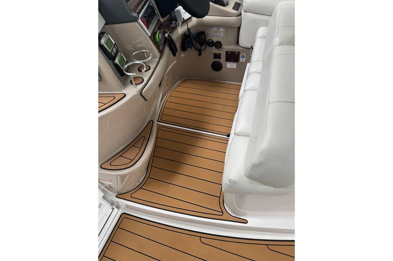 Slide: The Image of Interior of 2006 Four Winns H350 boat with wood-style flooring and white seating. - 48