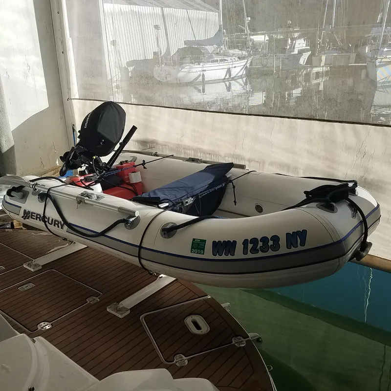 Slide: The Image of Inflatable boat with Mercury motor docked on a Four Winns 350, 2006 model. - 5