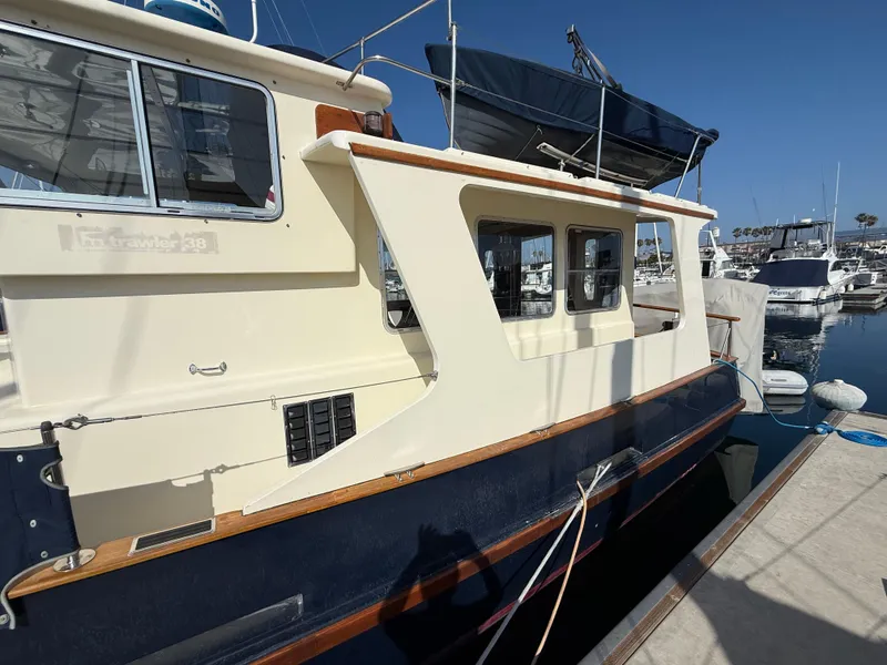 Slide: The Image of 1978 Fisher 38 Trawler docked at marina under clear blue sky. - 11