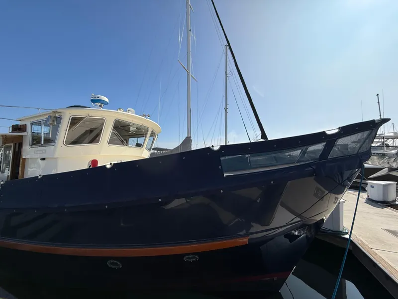 Slide: The Image of 1978 Fisher 38 Trawler docked, showcasing classic design and sturdy build. - 17