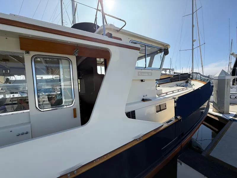 Slide: The Image of 1978 Fisher 38 Trawler docked at marina under clear sky. - 19