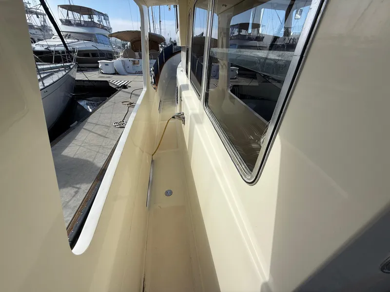 Slide: The Image of 1978 Fisher 38 Trawler side deck view at marina. - 22