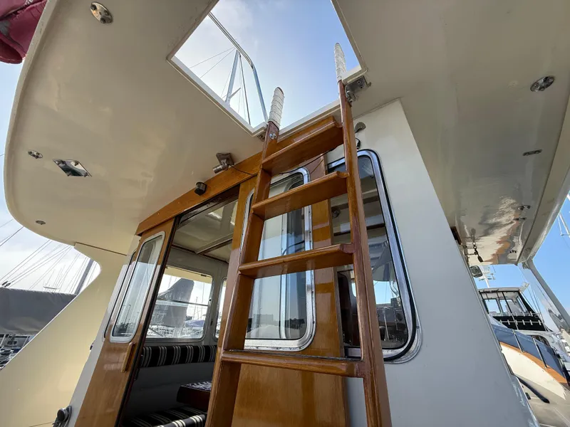 Slide: The Image of 1978 Fisher 38 Trawler interior with wooden ladder and open hatch. - 24
