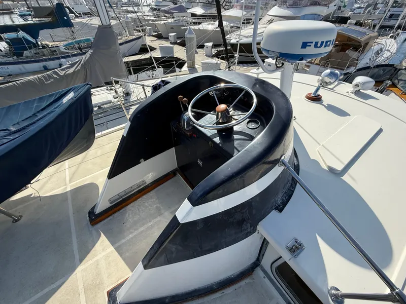 Slide: The Image of Helm of 1978 Fisher 38 Trawler with steering wheel and navigation equipment. - 26