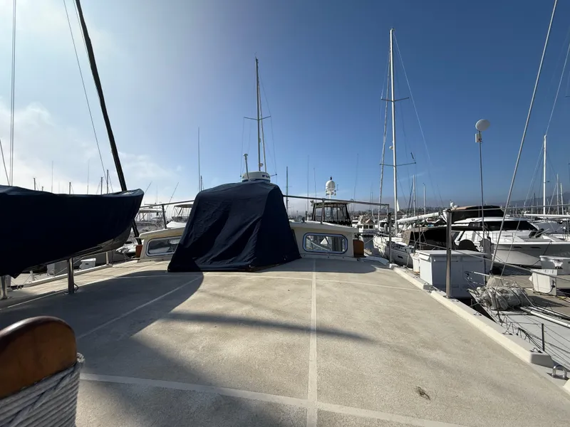Slide: The Image of 1978 Fisher 38 Trawler docked at marina under clear blue sky. - 30