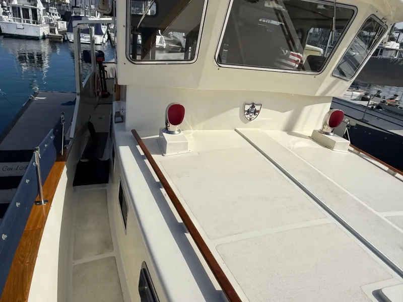 Slide: The Image of 1978 Fisher 38 Trawler docked at marina, showcasing deck and cabin details. - 40