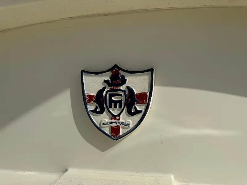 Slide: The Image of Emblem on 1978 Fisher 38 Trawler, featuring a shield design with nautical elements. - 41