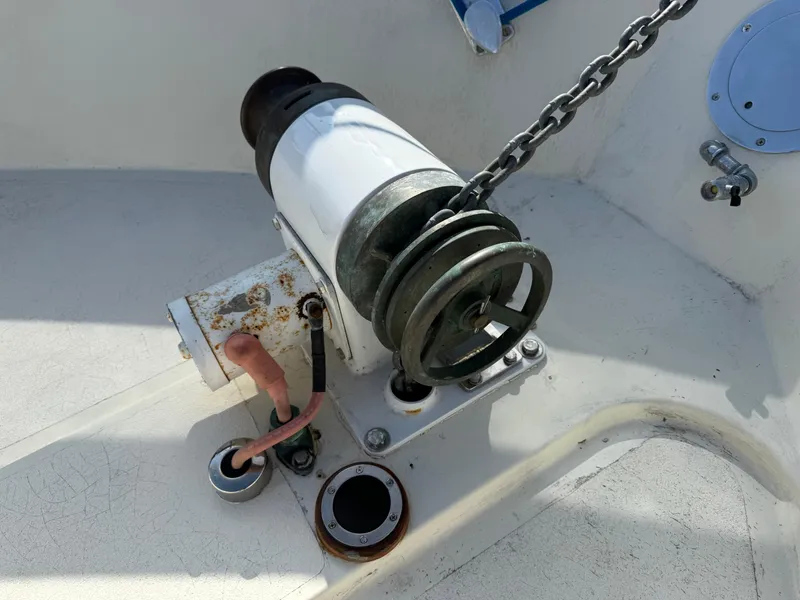 Slide: The Image of Anchor winch on 1978 Fisher 38 Trawler deck, featuring chain and mechanical components. - 44
