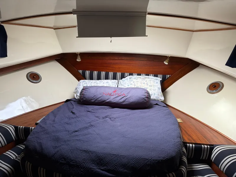 Slide: The Image of Cozy cabin interior of 1978 Fisher 38 Trawler with a neatly made bed. - 49