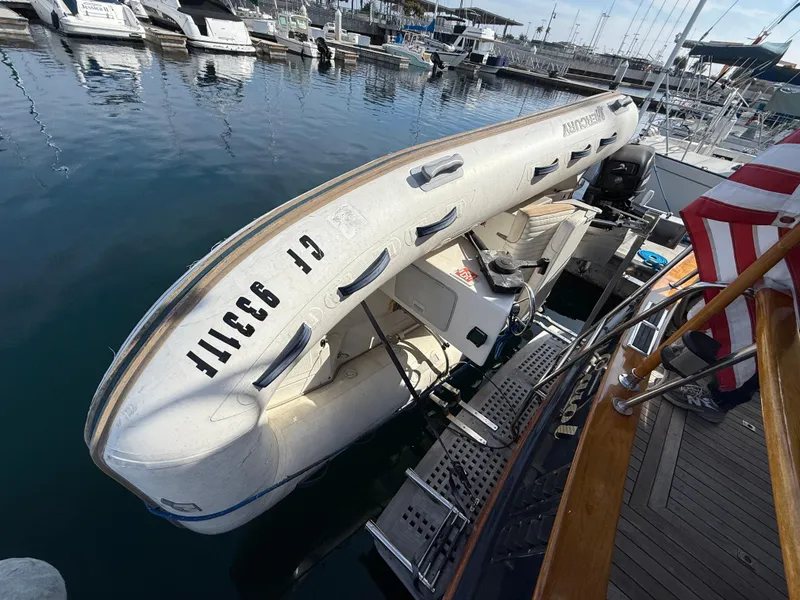 Slide: The Image of 1978 Fisher 38 Trawler with dinghy docked at marina, showcasing nautical equipment. - 8