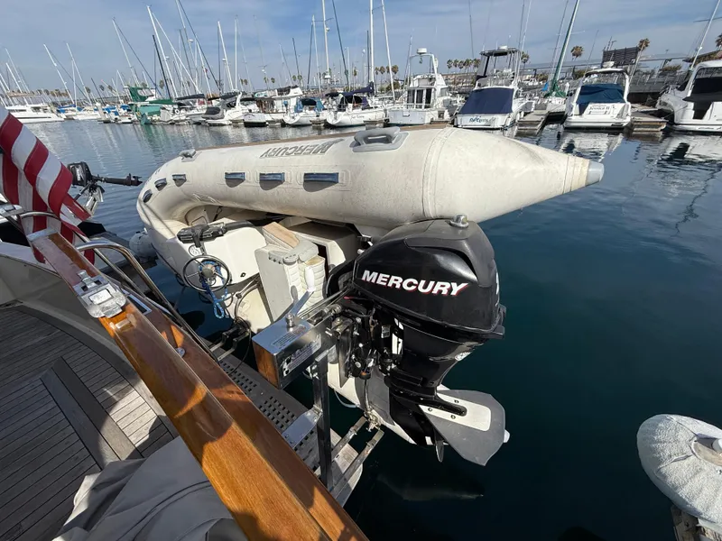 Slide: The Image of Inflatable boat with Mercury motor on 1978 Fisher 38 Trawler, docked in marina. - 9
