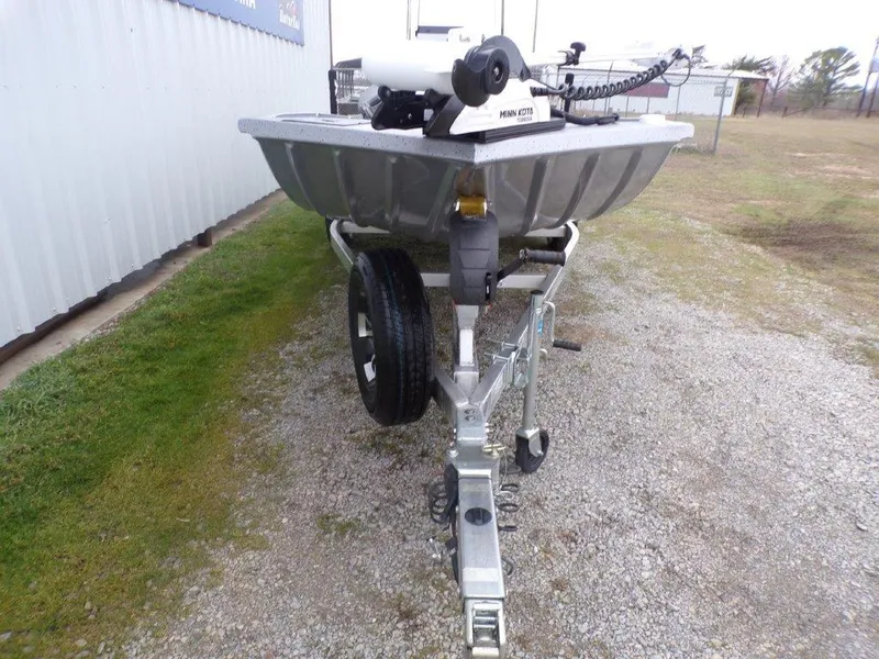 Slide: The Image of 2025 Xpress SW20B boat on trailer, parked on gravel near a building. - 17