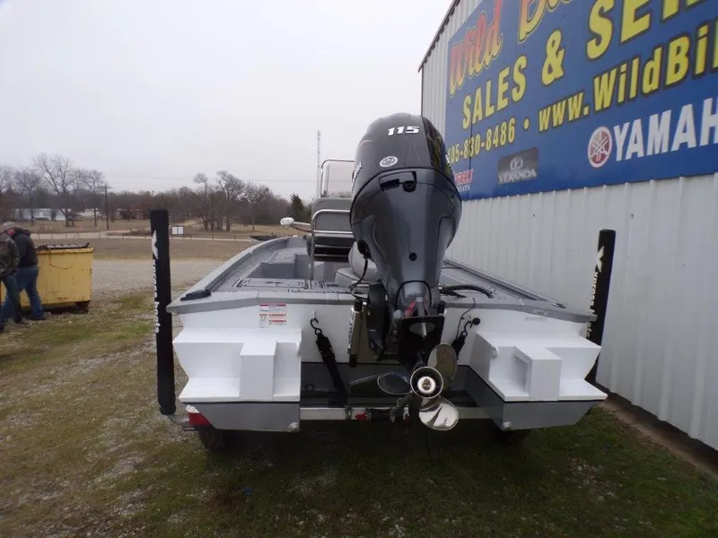 Slide: The Image of 2025 Xpress SW20B boat with Yamaha 115 engine, displayed at dealership. - 2