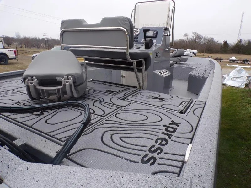 Slide: The Image of 2025 Xpress SW20B boat with custom deck design and seating, parked outdoors. - 22