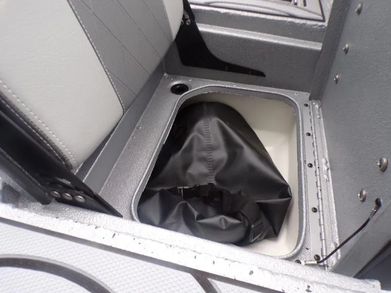 Slide: The Image of Storage compartment in 2025 Xpress SW20B boat with black bag inside. - 23