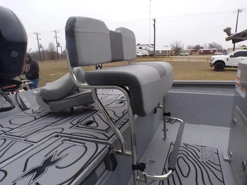 Slide: The Image of 2025 Xpress SW20B boat with gray seating and patterned flooring. - 25