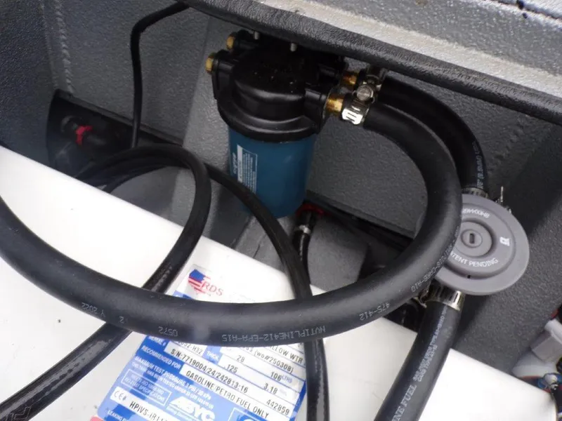 Slide: The Image of 2025 Xpress SW20B boat engine compartment with hoses and filter system. - 29