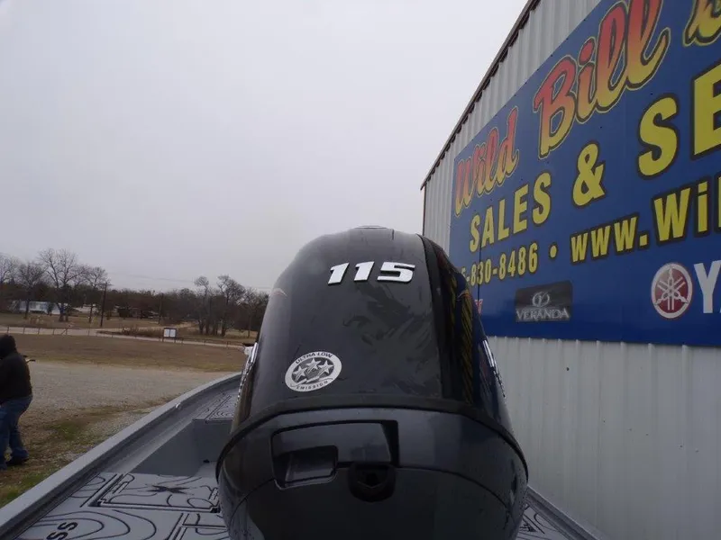 Slide: The Image of Outboard motor on Xpress SW20B boat, 2025 model, near sales and service building. - 6