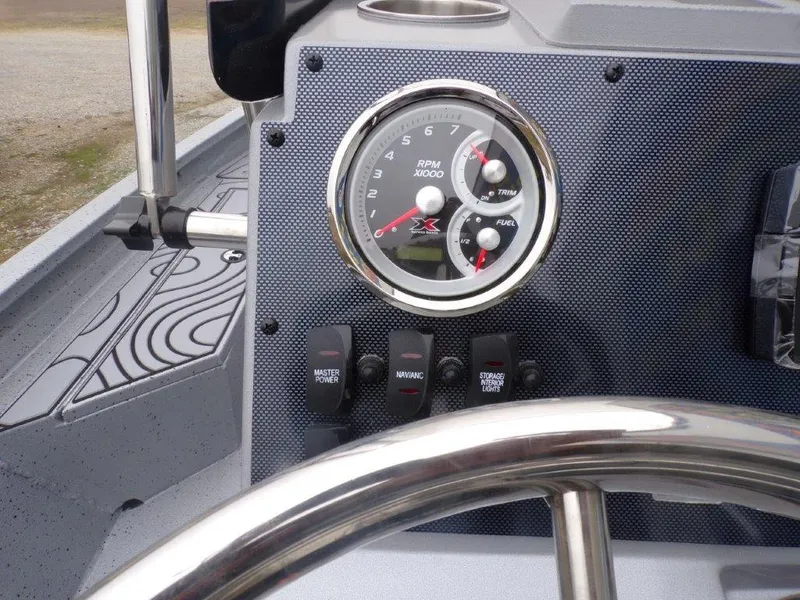 Slide: The Image of 2025 Xpress SW20B boat dashboard with RPM gauge and control switches. - 8