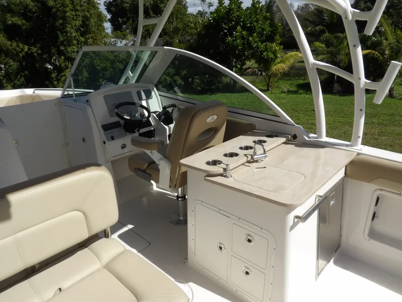 Slide: The Image of 2020 Sailfish 275 DC boat interior with helm, seating, and storage compartments. - 16