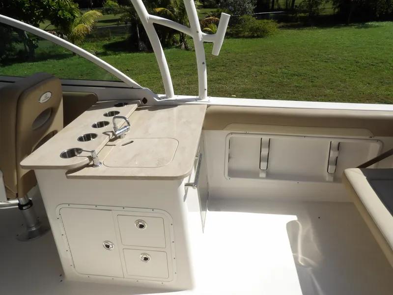 Slide: The Image of 2020 Sailfish 275 DC boat interior with cup holders and storage compartments. - 17