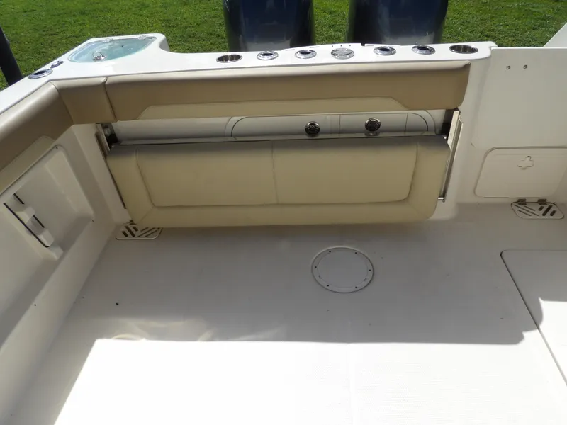 Slide: The Image of 2020 Sailfish 275 DC boat interior with foldable seating and clean deck. - 19