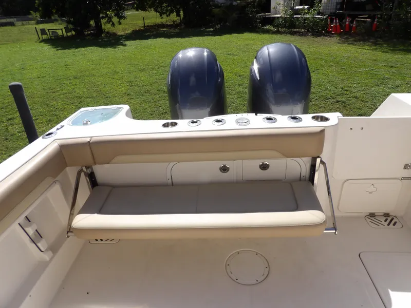 Slide: The Image of 2020 Sailfish 275 DC boat interior with seating and dual engines. - 20