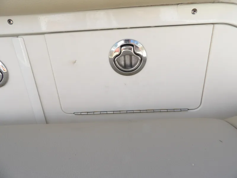 Slide: The Image of Storage compartment on a 2020 Sailfish 275 DC boat with a chrome handle. - 21