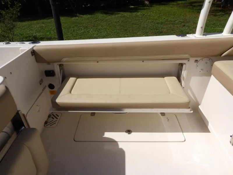 Slide: The Image of 2020 Sailfish 275 DC boat interior with beige fold-down seat and white deck. - 24