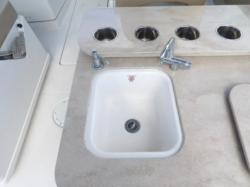 Slide: The Image of Sailfish 275 DC 2020 boat sink with faucet and cup holders on countertop. - 30