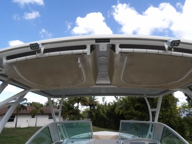 Slide: The Image of 2020 Sailfish 275 DC boat with overhead canopy and clear skies. - 32