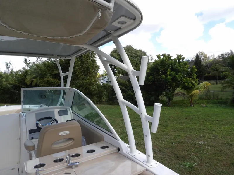 Slide: The Image of 2020 Sailfish 275 DC boat interior with steering wheel and rod holders. - 33
