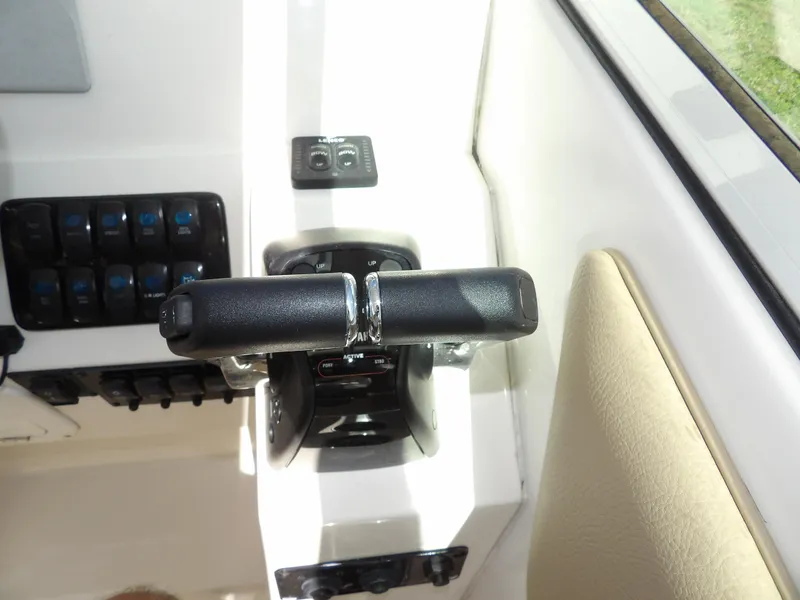 Slide: The Image of Throttle controls on a 2020 Sailfish 275 DC boat dashboard. - 38