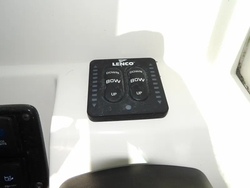 Slide: The Image of Lenco trim tab control on 2020 Sailfish 275 DC boat dashboard. - 39