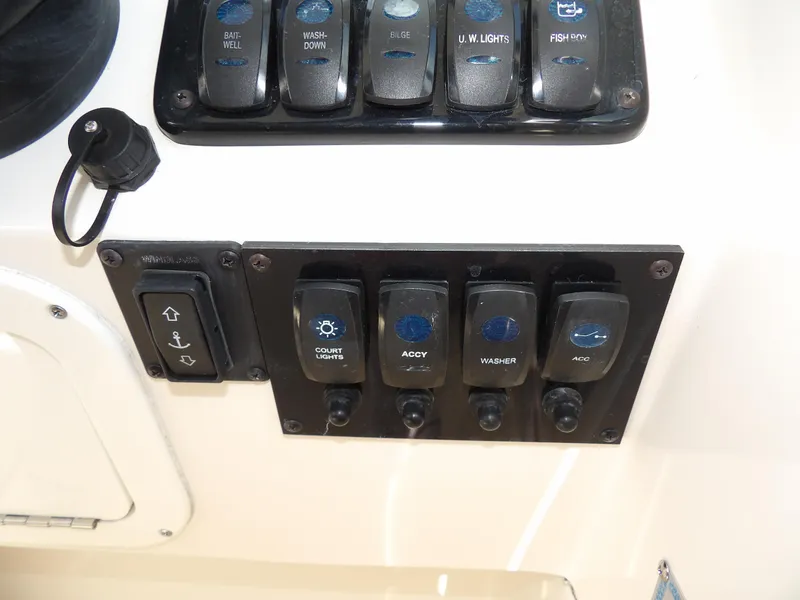 Slide: The Image of Control panel of a 2020 Sailfish 275 DC boat with various switches. - 41